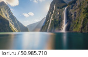 Witness the breathtaking view of a magnificent waterfall in an incredibly serene mountain landscape. Стоковое AI-видео, аниматор Лариса Пономарева / Фотобанк Лори