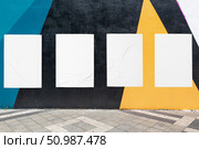 geometrical wall and four white glued wrinkled poster templates. Стоковое фото, фотограф Александра Конопля / Фотобанк Лори