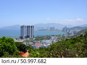 NHA TRANG, VIETNAM - APRIL 28, 2025. View from the mountain to the city with skyscrapers on the shore of the Gulf of the South China Sea. Редакционное фото, фотограф Сергей Фролов / Фотобанк Лори
