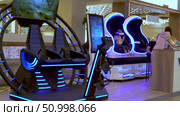 Explore the Future of Gaming with Cutting-Edge Virtual Reality Experiences Showcased in a Vibrant Retail Space Featuring Immersive Technology Stations. Стоковое видео, видеограф Владимир Федоров / Фотобанк Лори