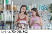 Mom and teen girl child buyer select feminine pads. Стоковое видео, видеограф Яков Филимонов / Фотобанк Лори