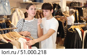 As they tried on different jumpers, they considered colors and styles for chilly season. Стоковое видео, видеограф Яков Филимонов / Фотобанк Лори