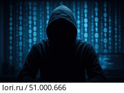 A Mysterious Figure in a Hooded Sweatshirt Surrounded by Glowing Binary Code, Symbolizing Cyber Security and Digital Anonymity. Стоковое AI-изображение, AI-художник Башкирова Анна / Фотобанк Лори
