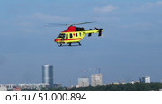 Air ambulance helicopter flying over urban area with tall buildings. Стоковое видео, видеограф Strunov David / Фотобанк Лори