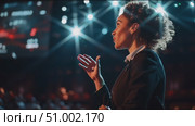 Engaging speaker presents at a dynamic conference in a vibrant venue with an energetic atmosphere and interactive audience. Стоковое AI-видео, аниматор Сергей Толмачёв / Фотобанк Лори