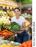 Girl client near vegetable stand in store choose cabbage. Стоковое фото, фотограф Яков Филимонов / Фотобанк Лори