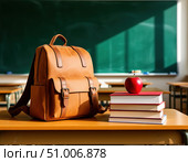 A school backpack stands on a desk next to a stack of books and an apple against a blackboard. Стоковое AI-изображение, AI-художник Ирина Самойлова / Фотобанк Лори