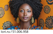 A striking portrait features a woman with natural curls and elegant earrings set against a vibrant orange background, reflecting rich heritage. Стоковое AI-видео, аниматор Данила Большаков / Фотобанк Лори