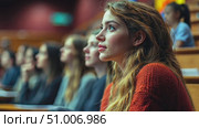 A young woman with long hair focuses intently while attending a lecture in a university auditorium filled with students. Стоковое AI-видео, аниматор Данила Большаков / Фотобанк Лори