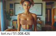 A young woman stands poised in a bright living room, showcasing her casual summer outfit while capturing a relaxed and confident vibe. Стоковое AI-видео, аниматор Данила Большаков / Фотобанк Лори