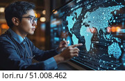 A young expert engaged in data analysis on a high-tech digital screen, focusing on global information in a well-lit office environment. Стоковое AI-видео, аниматор Данила Большаков / Фотобанк Лори
