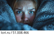 A woman appears terrified, wrapped in blankets, as she looks around the dark room, conveying a sense of dread and tension in the atmosphere. Стоковое AI-видео, аниматор Данила Большаков / Фотобанк Лори