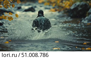 A person dressed in a dark jacket walks through a stream, surrounded by vibrant autumn leaves and serene scenery during the evening. Стоковое AI-видео, аниматор Данила Большаков / Фотобанк Лори