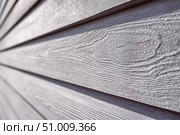 Modern grey wood plank texture. Fiber cement siding. Exterior of composite wall. Plastic material is eco-friendly polymer panels in rows. Wooden grain surface. Hollow WPC boards. Dark oak color. PE. Стоковое AI-изображение, AI-художник Марина Демидюк / Фотобанк Лори