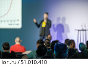 Speaker presenting to audience at business event with presentation screen. Стоковое фото, фотограф Антон Гвоздиков / Фотобанк Лори