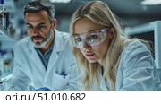 A team of scientists collaborates in a well-equipped laboratory, conducting intricate experiments and analyzing chemical substances together. Стоковое AI-видео, аниматор Данила Большаков / Фотобанк Лори