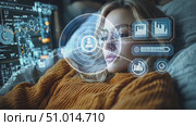 A young woman in a cozy sweater interacts with a high-tech digital interface, deep in focus during the evening hours while relaxing at home. Стоковое AI-видео, аниматор Данила Большаков / Фотобанк Лори