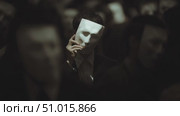 Crowd of masked figures in dark setting creates an eerie atmosphere during a mysterious night event. Стоковое AI-видео, аниматор Сергей Толмачёв / Фотобанк Лори