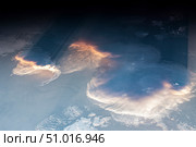View from space of anvil cumulus clouds, crepuscular rays and Rayleigh scattering. Стоковое фото, фотограф Stocktrek Images, Inc. / ТАСС / Фотобанк Лори