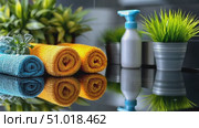 Explore the beautiful arrangement of colorful towels alongside lush greenery, ideal for enhancing your bathroom decor and ambiance. Стоковое AI-видео, аниматор Данила Большаков / Фотобанк Лори