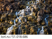 Brine falls from volcanic rock drop off to a runoff stream. Стоковое фото, фотограф Stocktrek Images, Inc. / ТАСС / Фотобанк Лори