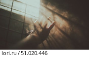 Desperate touch in a dimly lit room filled with dust and light revealing a moment of longing and isolation. Стоковое AI-видео, аниматор Сергей Толмачёв / Фотобанк Лори