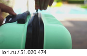 Man unzipping a suitcase for travel. Стоковое видео, видеограф Igor Skripachev / Фотобанк Лори