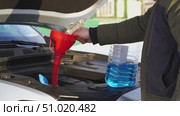 Driver pours winter windshield fluid into the car. Стоковое видео, видеограф Igor Skripachev / Фотобанк Лори