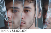 Reflection of emotions in fragmented glass reveals inner struggles and vulnerability. Стоковое AI-видео, аниматор Сергей Толмачёв / Фотобанк Лори