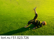 The child goes in for sports at the stadium. The boy training before playing football. Стоковое фото, фотограф Anastasia Kayander / Фотобанк Лори