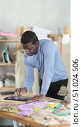 African American man tailor creates sketch of dress on tablet. Стоковое видео, видеограф Яков Филимонов / Фотобанк Лори