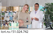 Young female client having severe abdominal pain while apothecary trying to help her in drugstore. Стоковое видео, видеограф Яков Филимонов / Фотобанк Лори