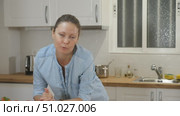 Positive housewife leaning on a kitchen set with vegetables while preparing salad. Стоковое видео, видеограф Яков Филимонов / Фотобанк Лори