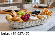 Wicker basket overflowing with delicious treats for a celebration. Стоковое AI-изображение, AI-художник Юрий Поздников / Фотобанк Лори