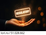 Hand Holding a Glowing 'Regulatory' Sign Symbolizing Compliance and Governance in Modern Business Environments and Financial Markets. Стоковое AI-изображение, AI-художник Башкирова Анна / Фотобанк Лори