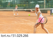 Woman playing tennis against female opponent on tennis court. Стоковое фото, фотограф Яков Филимонов / Фотобанк Лори