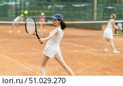 Woman playing tennis against female opponent on tennis court. Стоковое фото, фотограф Яков Филимонов / Фотобанк Лори