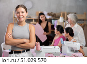 Young woman standing against background of female attendees of dressmaking courses. Стоковое фото, фотограф Яков Филимонов / Фотобанк Лори