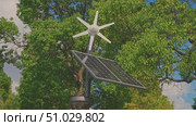 Tokyo, Japan - Oct 13 2024, 4k, panoramic view of the top of a street lamp with solar panels and a small wind turbine, without people, at daytime, in park in Tokyo, Japan. Стоковое видео, видеограф Сергей Богомяко / Фотобанк Лори