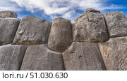 A fragment of an ancient stone wall. Ruins of a Magnificent Inca Fortress Sacsayhuaman. The huge boulders are tightly fitted and sanded using the Ashlar polygonal masonry technique. Peru. Cusco. Стоковое фото, фотограф Вера Ивановна Кубарева / Фотобанк Лори