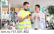 Builder with a helmet in hands chooses an medical expectorant cough syrup. Стоковое видео, видеограф Яков Филимонов / Фотобанк Лори