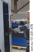 Moscow, Russia, July 3, 2025. A process engineer opens the compressor panel and starts up the equipment. Редакционное видео, видеограф Юрий Поздников / Фотобанк Лори
