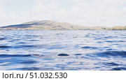 Lake Bannoe, Russian Federation - July 31, 2025: Serene lake view with gentle ripples reflecting clouds and distant hills under a bright blue sky, showcasing natural beauty and tranquility. Редакционное видео, видеограф Ирина Ручушкина / Фотобанк Лори