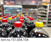 A row of soda bottles with red and yellow caps. Стоковое фото, фотограф Ярославский Максим / Фотобанк Лори