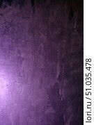 Textured surface of the wall, painted in purple with a soft gradient of lighting. The surface shows strokes and irregularities of the plaster, creating an artistic effect and depth of texture. Abstract background suitable for design projects, photo collages and presentations. Стоковое фото, фотограф Анна Кривицкая / Фотобанк Лори