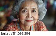 An elder woman reflects on her rich life experiences while surrounded by the colorful ambiance of a busy Bali marketplace. Стоковое AI-видео, аниматор Данила Большаков / Фотобанк Лори