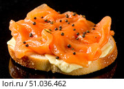 Gourmet appetizer with smoked salmon and cream cheese on toasted bread, delicious canape on black background for restaurant menu concepts. Стоковое AI-изображение, AI-художник Павел Муравьев / Фотобанк Лори