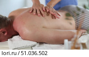 Man gets back massage, close-up. Female masseur works out back and lower back area of male client. Стоковое видео, видеограф Яков Филимонов / Фотобанк Лори