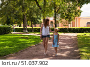 Cherishing a Sunny Afternoon Walk in Gatchina Park With Mom and Daughter. Стоковое фото, фотограф Aleksandr Golubev / Фотобанк Лори