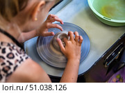 Shaping Dreams Young Girl Learns Pottery in Her First Workshop. Стоковое фото, фотограф Aleksandr Golubev / Фотобанк Лори